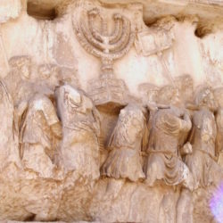 1024px Carrying_off_the_Menorah_from_the_Temple_in_Jerusalem_depicted_on_a_frieze_on_the_Arch_of_Titus_in_the_Forum_Romanum